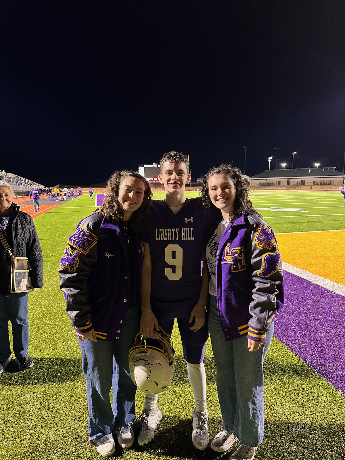 The Miller family at Liberty Hill ISD high school football game under the stadium lights